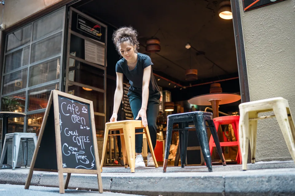 Café worker arranging outdoor seating
