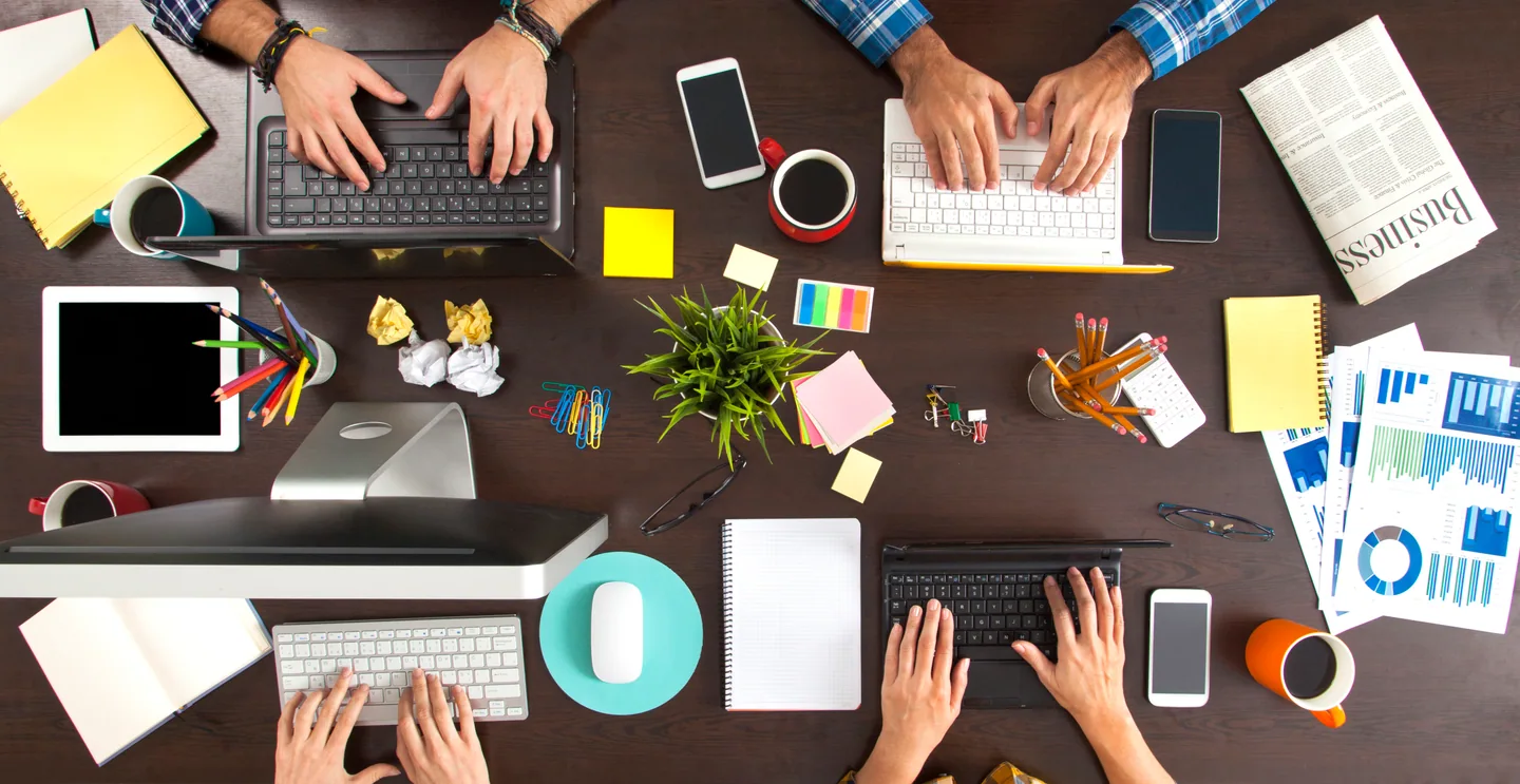 Overhead view of a team working together around a table